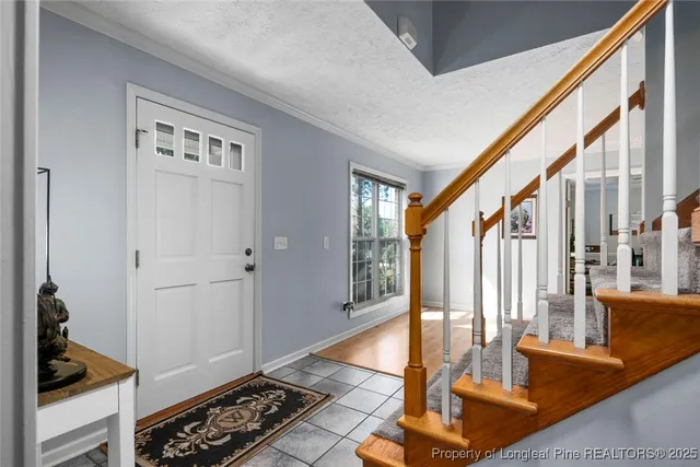 a view of front door with hallway and a livingroom