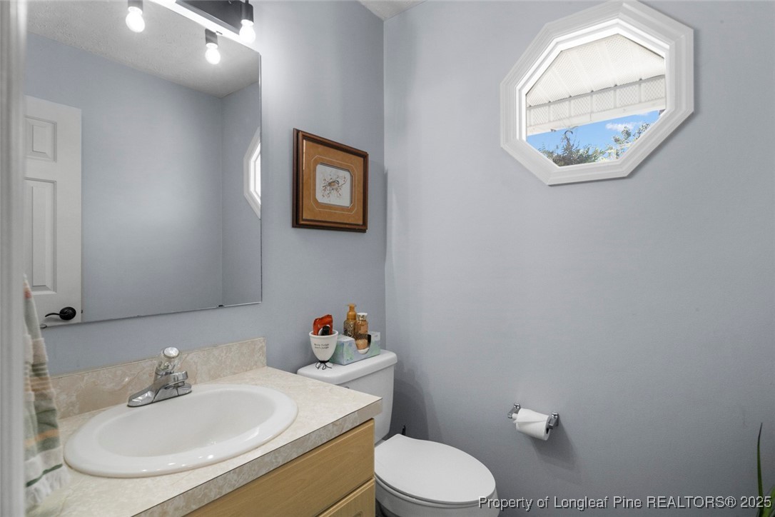 59 Prestige Drive Cameron, NC 28326 - Photo 21 of 36 a bathroom with a toilet sink and mirror