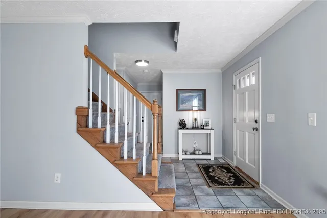 a view of a hallway with wooden floor and staircase