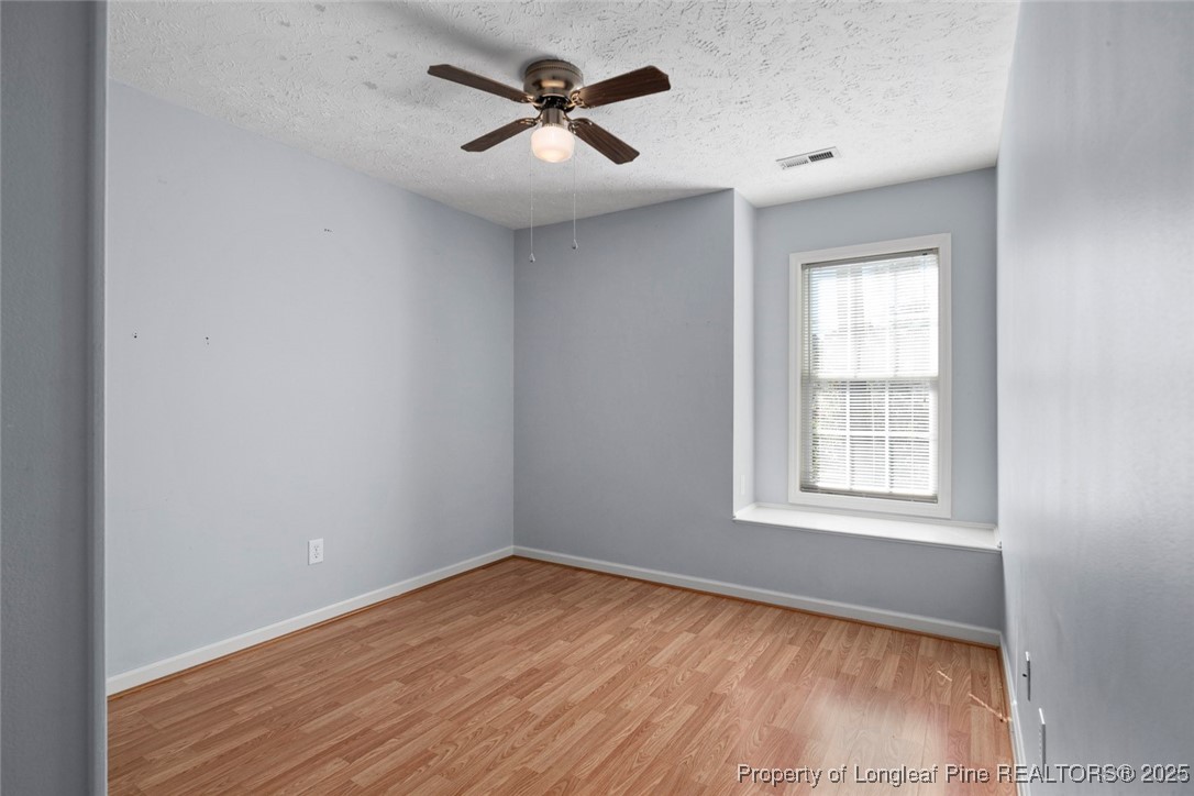 59 Prestige Drive Cameron, NC 28326 - Photo 23 of 36 an empty room with wooden floor and windows