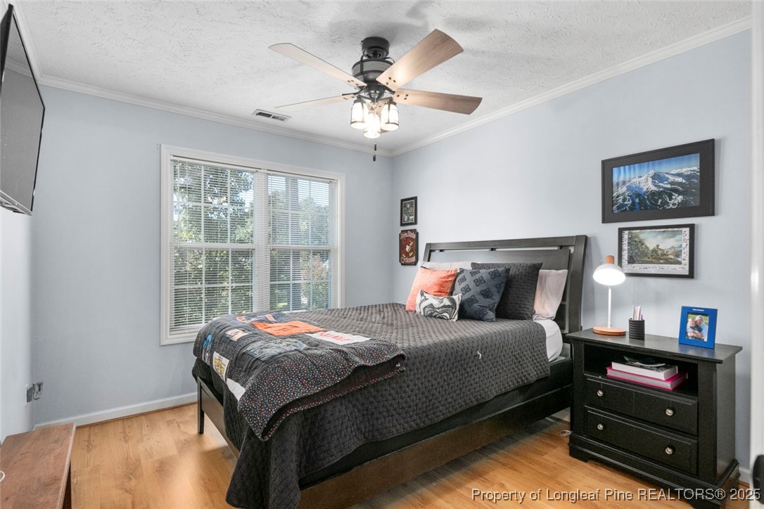 59 Prestige Drive Cameron, NC 28326 - Photo 25 of 36 a bedroom with a bed and a chandelier