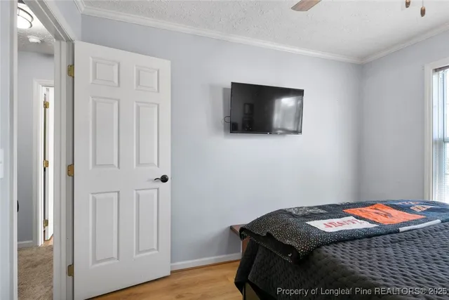 a bedroom with a bed and flat screen tv