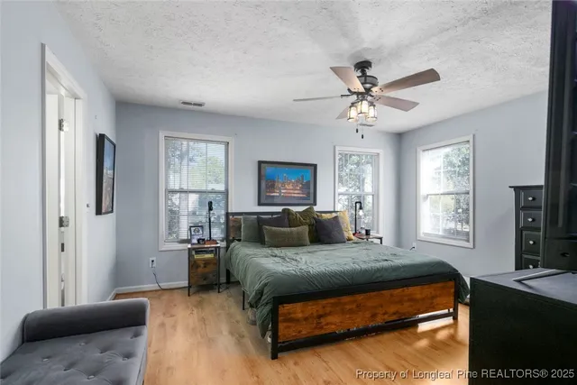 a living room with a bed furniture and a window