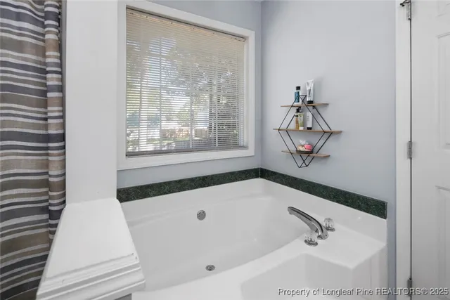 a bathroom with a tub and a window