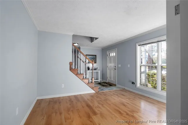 a view of entryway with wooden floor and stairs