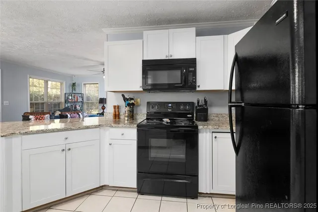 a kitchen with a refrigerator and a stove top oven