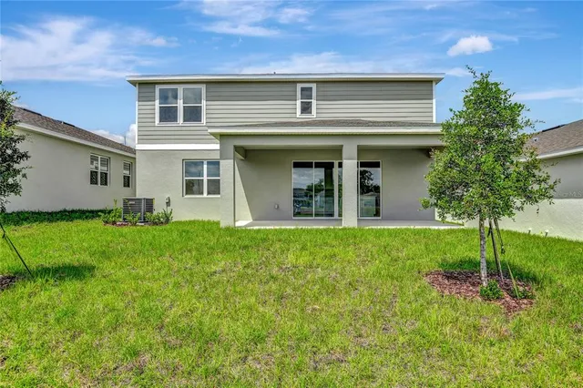 a view of an house with backyard space and garden