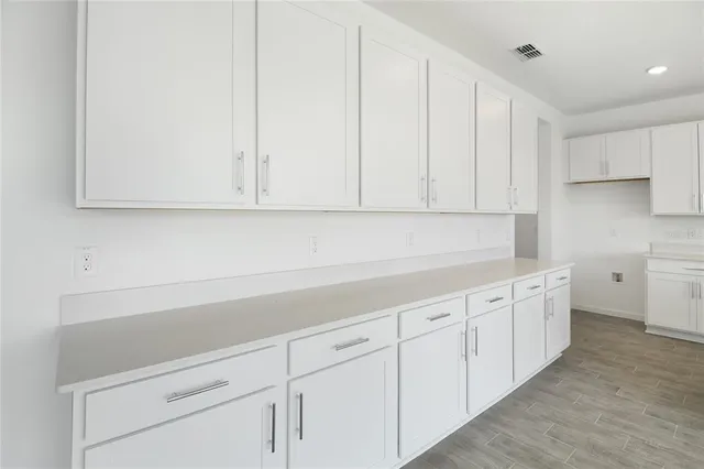 a kitchen with white cabinets and white appliances