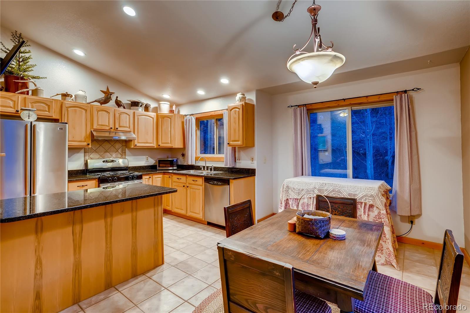 7120 County Road 43 Bailey, CO 80421 - Photo 18 of 37 a kitchen with a refrigerator and a stove