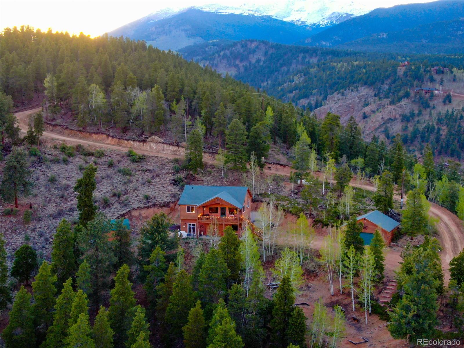 7120 County Road 43 Bailey, CO 80421 - Photo 3 of 37 an aerial view of a houses with a lush green hillside