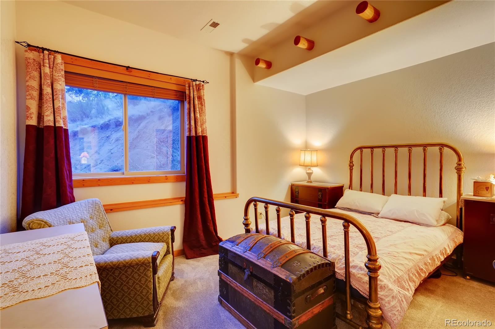 7120 County Road 43 Bailey, CO 80421 - Photo 33 of 37 a bedroom with furniture and a window