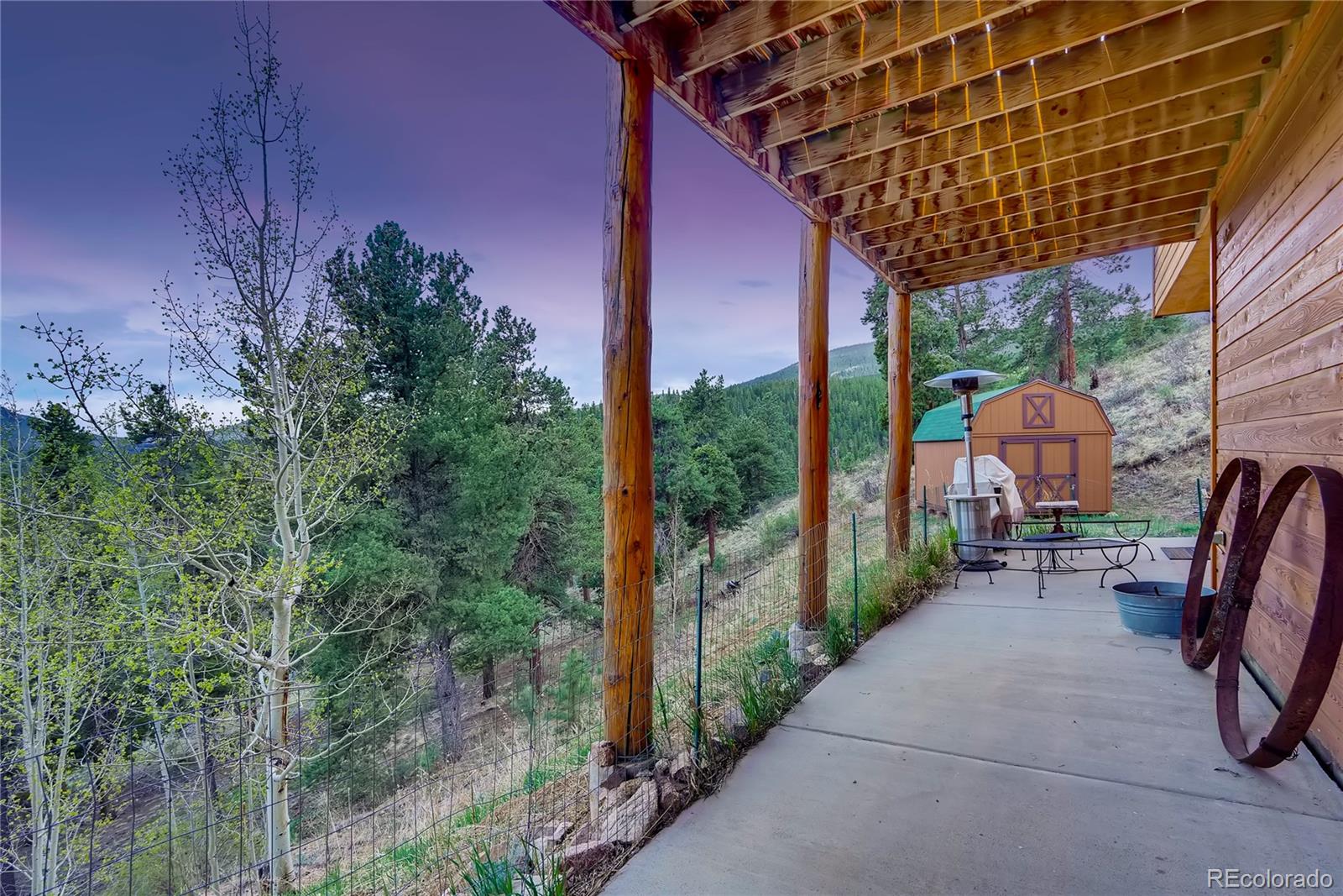 7120 County Road 43 Bailey, CO 80421 - Photo 36 of 37 a backyard of a house with table and chairs with plants