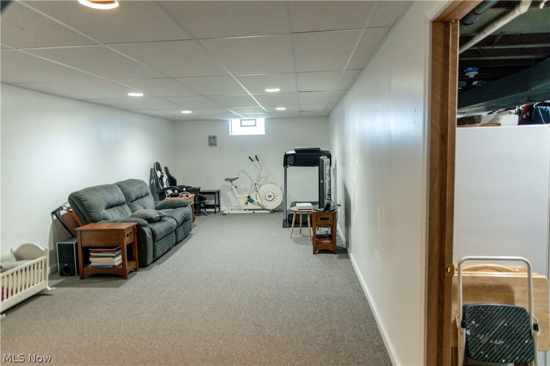 4750 Turney Road Madison, OH 44057 - Photo 16 of 42 Carpeted living room with a drop ceiling