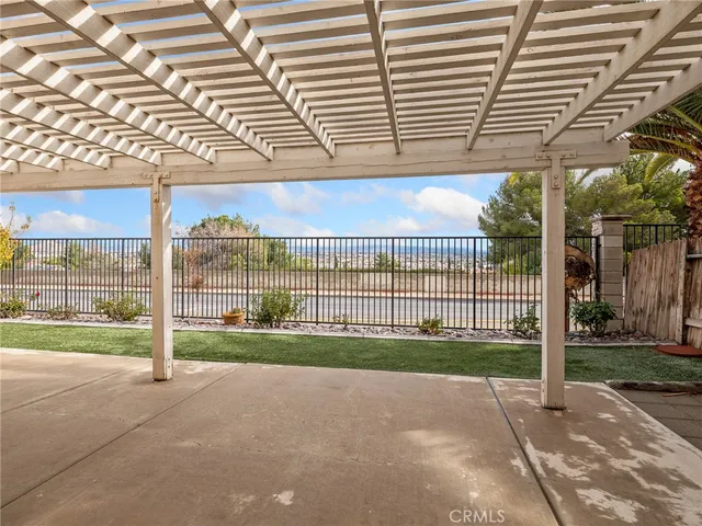 a view of a patio with table and chairs