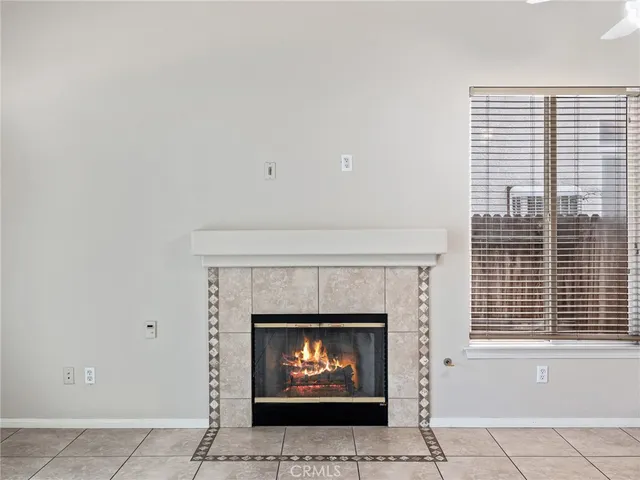 a living room with a fireplace and a window