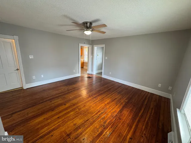 a view of an empty room and wooden floor