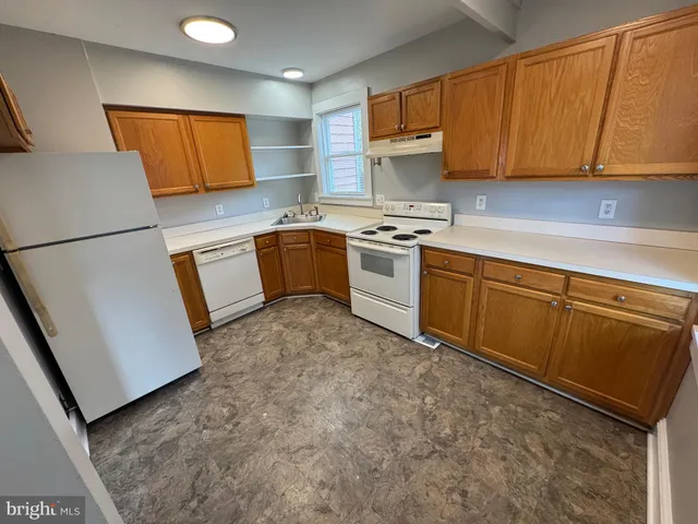 a kitchen with stainless steel appliances granite countertop a refrigerator sink stove and microwave