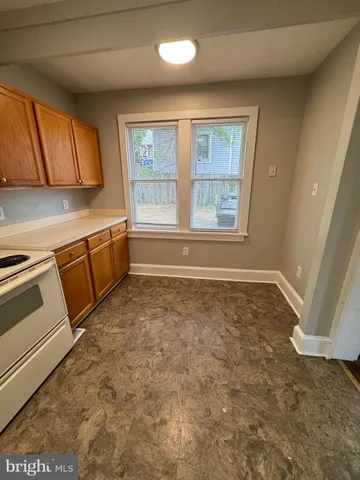 a view of a kitchen with microwave and windows