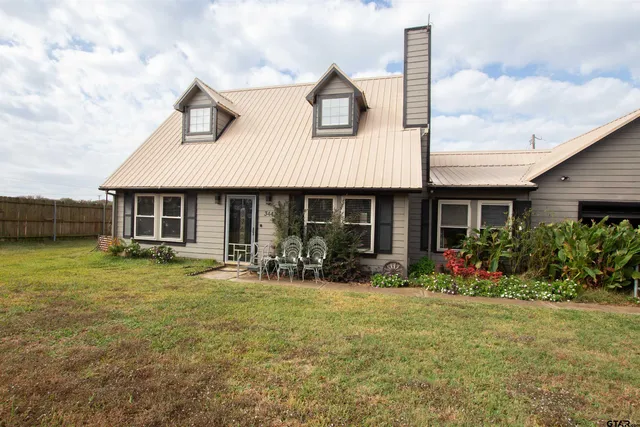 a front view of a house with yard and porch