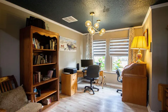a view of a livingroom with workspace and a window