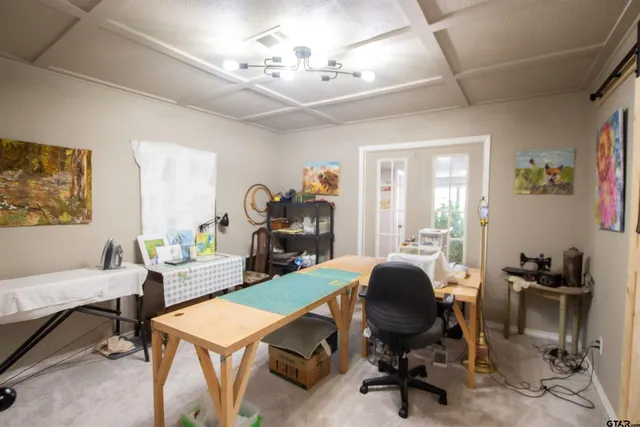 a view of a livingroom with workspace and a window