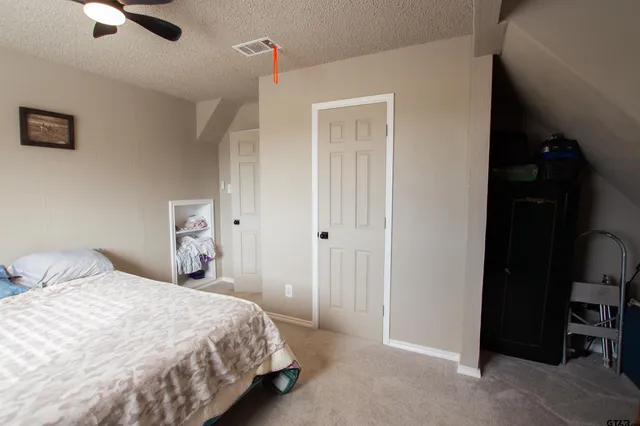 a bedroom with a bed and a cabinet