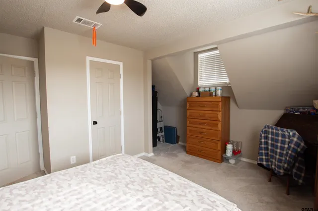 a bedroom with a bed and a chair