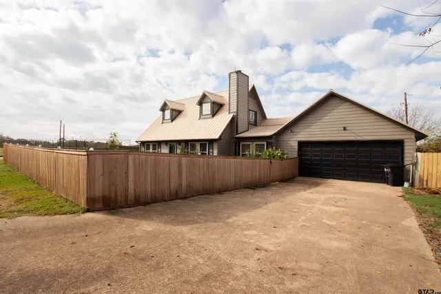 a backyard of a house with wooden fence