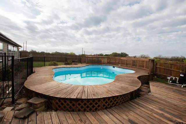 a view of a swimming pool with a patio