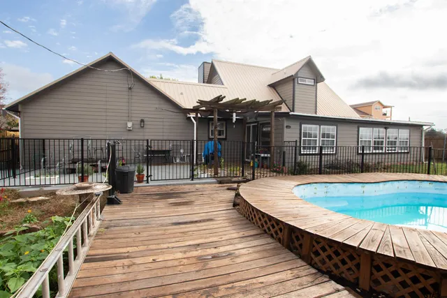 a view of a house with swimming pool and sitting area