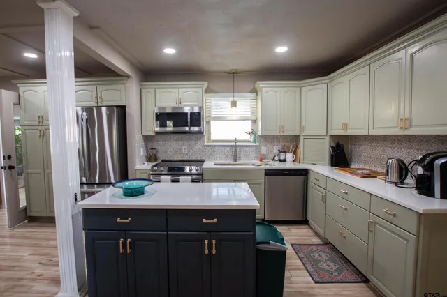 a kitchen with a sink stove and refrigerator