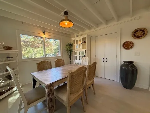 a view of a dining room and livingroom with furniture window and outside view