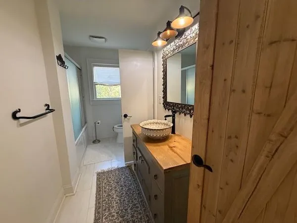 a bathroom with a sink toilet and shower