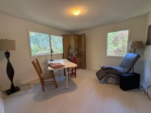 a view of a livingroom with furniture and a window