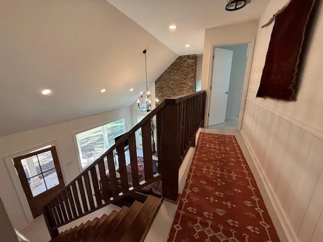 a view of hallway with stairs and wooden floor