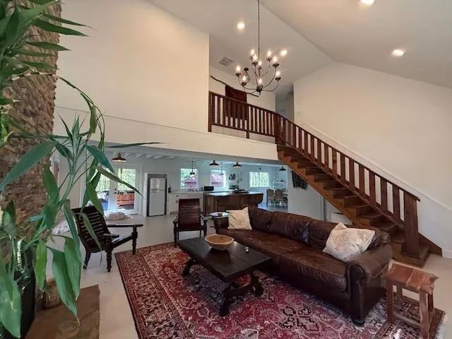a living room with furniture and a chandelier
