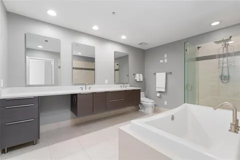 a large bathroom with a double vanity sink mirror and double