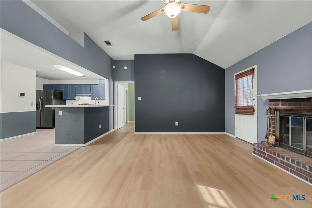 3624 Rainforest Lane Killeen, TX 76549 - Photo 12 of 27 a view of kitchen and empty room with a fireplace