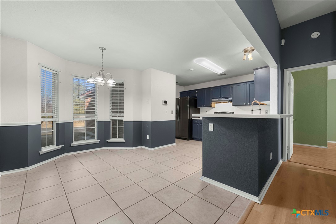 3624 Rainforest Lane Killeen, TX 76549 - Photo 13 of 27 a kitchen with kitchen island granite countertop a sink cabinets and stainless steel appliances
