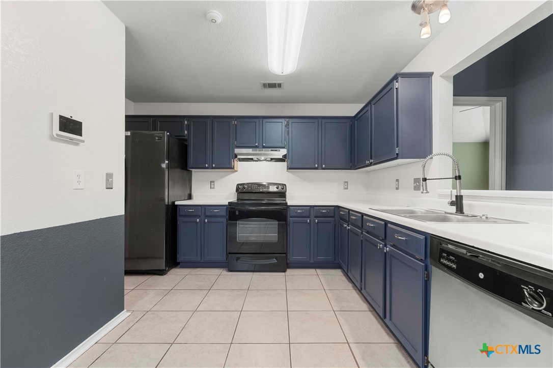 3624 Rainforest Lane Killeen, TX 76549 - Photo 21 of 27 a kitchen with stainless steel appliances granite countertop a refrigerator and a stove