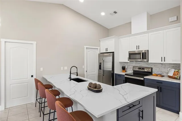 a kitchen with a sink a stove and refrigerator
