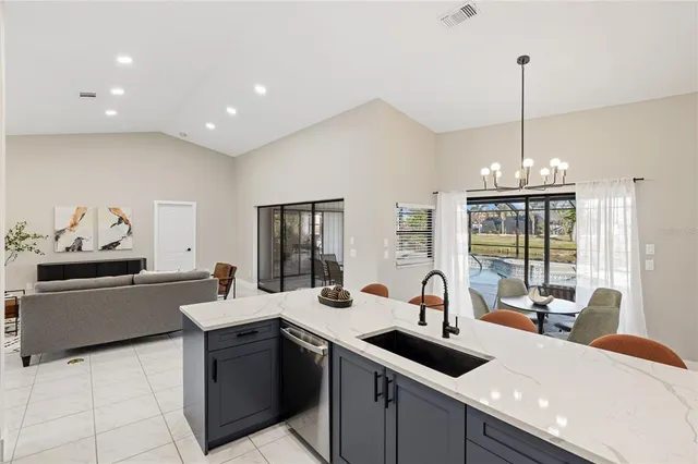 a kitchen with stainless steel appliances a sink stove and cabinets