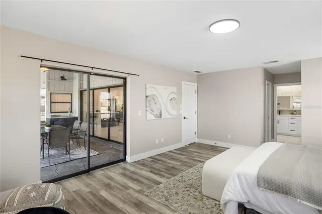 a bedroom with a bed and a mirror