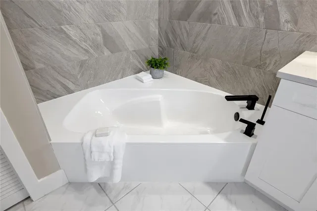 a bathroom with a double vanity sink toilet and shower