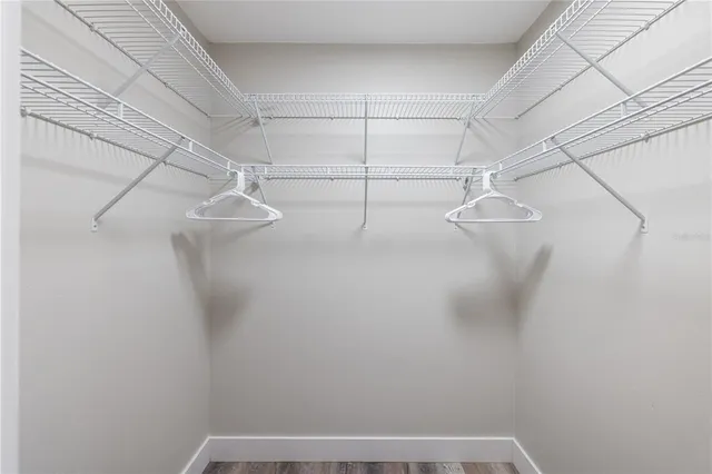 a dining room with furniture and a floor to ceiling window