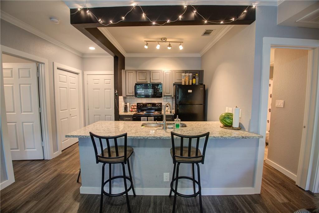 2606 Rio Grande Street, Unit 101 Austin, TX 78705 - Photo 1 of 24 a view of a dining room with furniture and wooden floor