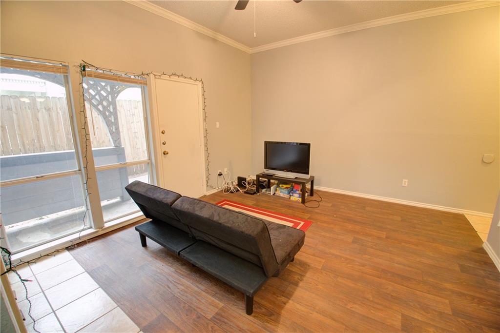 2606 Rio Grande Street, Unit 101 Austin, TX 78705 - Photo 17 of 24 a living room with a bed furniture and a flat screen tv