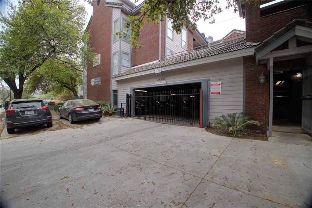 2606 Rio Grande Street, Unit 101 Austin, TX 78705 - Photo 23 of 24 a view of a car parked in front of a building
