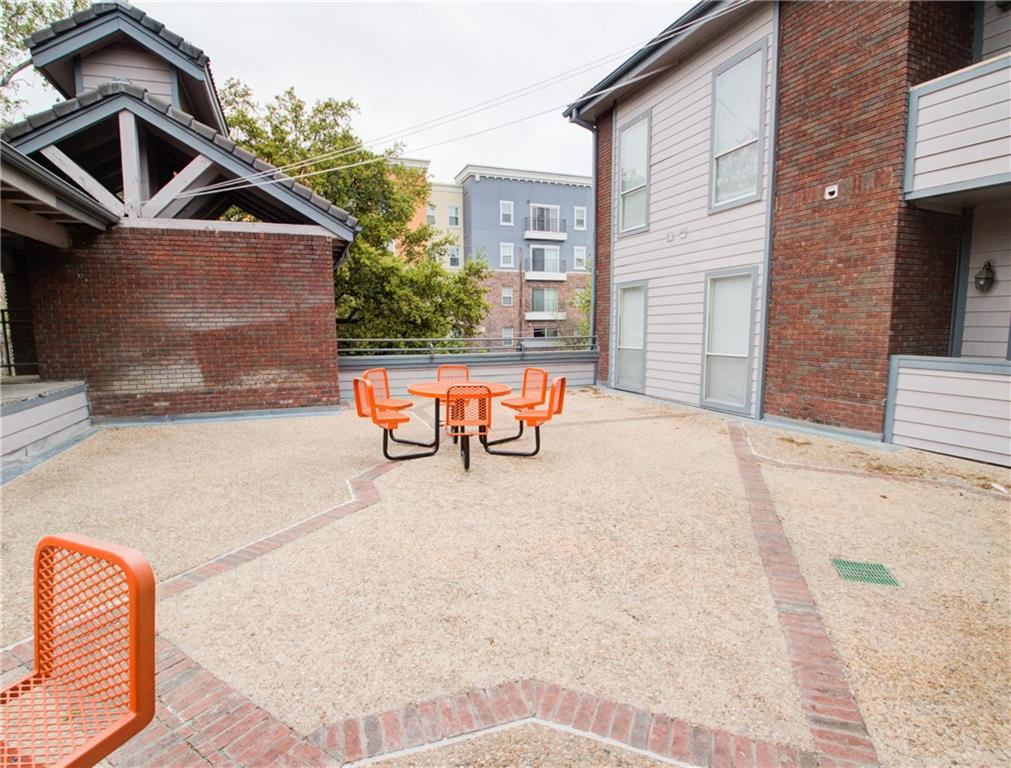 2606 Rio Grande Street, Unit 101 Austin, TX 78705 - Photo 24 of 24 a view of a house with a barbeque and wooden stairs