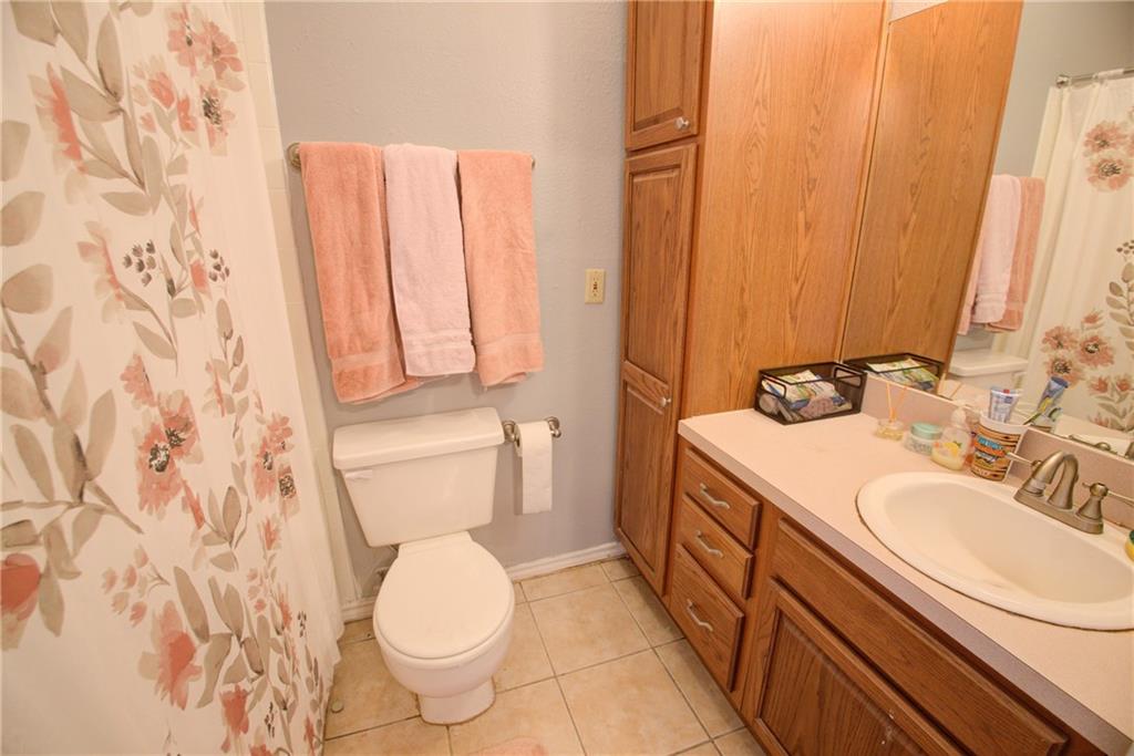 2606 Rio Grande Street, Unit 101 Austin, TX 78705 - Photo 8 of 24 a bathroom with a toilet sink and mirror